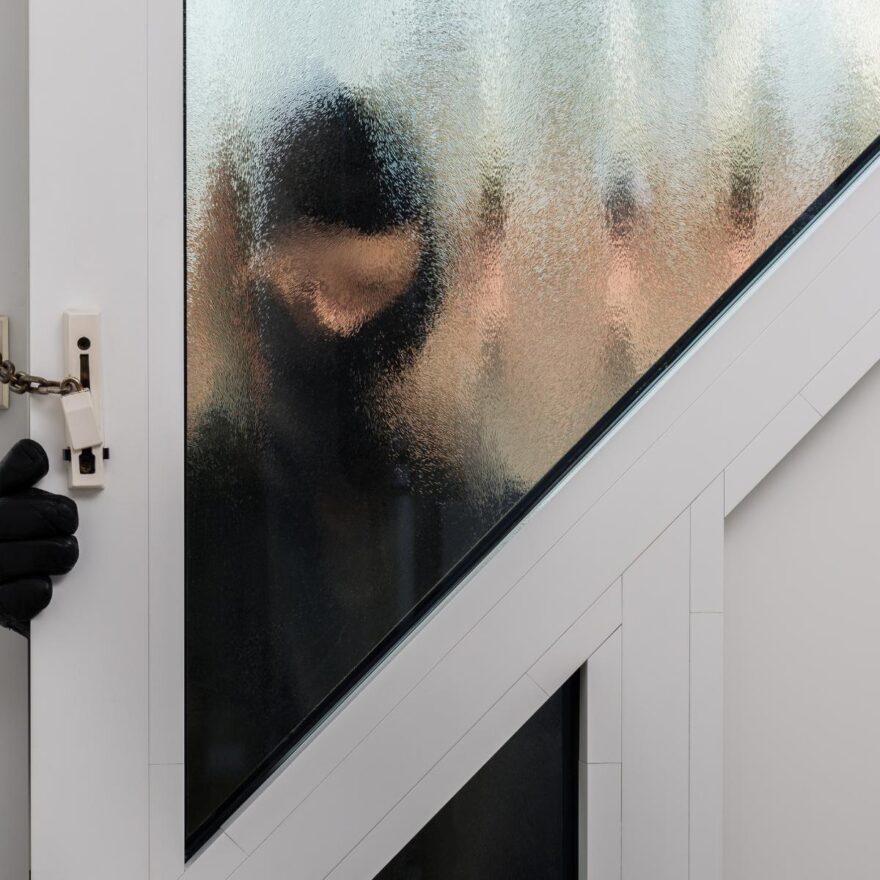 image of a thief breaking into a home