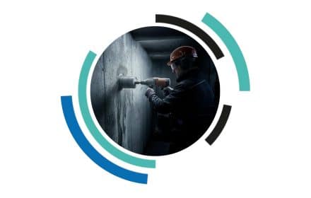 Core drill penetrating a strongroom wall demonstrating how attackers target structures and why a core drill proof strongroom is essential